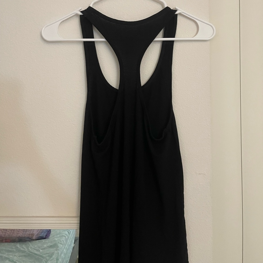 A black camisole in the size X small but runs a size larger